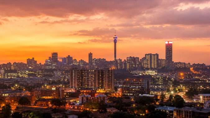 A city skyline at sunset, representing the communities a local service business may cover.